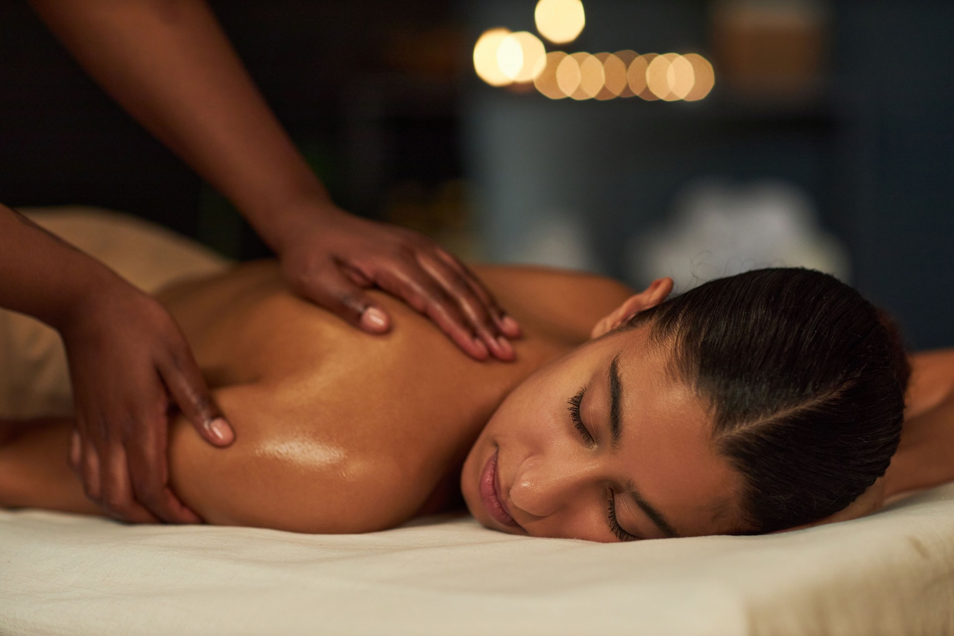 Receiving Relaxing Massage with Candles in Background